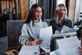 Two young beautiful women at a business meeting in a cafe Royalty Free Stock Photo