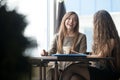 Two young beautiful women chatting in cafe Royalty Free Stock Photo