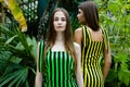 Young women in elegant striped dresses