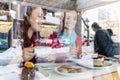 Two young and beautiful women enjoying cakes and coffee in a trendy cafe Royalty Free Stock Photo