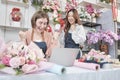 Two young beautiful female florist partners happily work as a florist Royalty Free Stock Photo