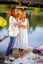 Two young beautiful women at a party near the water Royalty Free Stock Photo