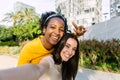 Two young beautiful women taking selfie portrait together in summer at city Royalty Free Stock Photo