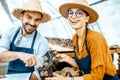 Man and woman working on the farm for snails growing Royalty Free Stock Photo