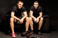 Two young boxers relax before a training session