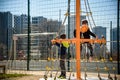 Two young boy active little child playing climbing at spring metal playground his hand to exercise at outdoor. Warm sunny day. Royalty Free Stock Photo