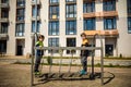 Two young boy active little child playing climbing at spring metal playground his hand to exercise at outdoor. Warm sunny day. Royalty Free Stock Photo