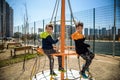 Two young boy active little child playing climbing at spring metal playground his hand to exercise at outdoor. Warm sunny day. Royalty Free Stock Photo