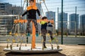 Two young boy active little child playing climbing at spring metal playground his hand to exercise at outdoor. Warm sunny day. Royalty Free Stock Photo