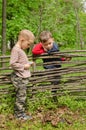 Two young boys discussing lighting a campfire Royalty Free Stock Photo