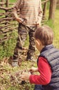 Two young boys discussing lighting a campfire Royalty Free Stock Photo