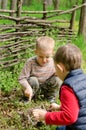 Two young boys discussing lighting a campfire Royalty Free Stock Photo