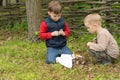 Two young boys lighting a fire outdoors Royalty Free Stock Photo