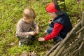 Two young boys lighting a small fire