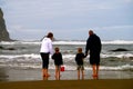 Family explores low tide tide pool on beach Royalty Free Stock Photo