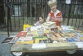 Two young boys selling books