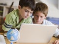 Two Young Boys Using A Laptop At Home Royalty Free Stock Photo