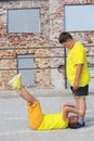 two young boys in yellow T-shirts are training. Training of abdominal muscles
