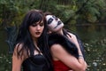 Two young brunettes women with makeup like a Halloween skull and