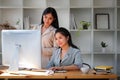 Two young business colleagues analysing financial data on computer at modern office Royalty Free Stock Photo