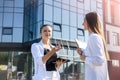 Two young business ladies posing outside office building. Women and business Royalty Free Stock Photo