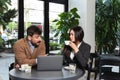 Two young business people having a successful meeting at restaurant. Businessman and businesswoman sitting in cafeteria working Royalty Free Stock Photo