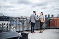 Two young business people standing on a terrace outside office, shaking hands. Royalty Free Stock Photo
