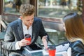 Two young business people using digital tablet on a meeting at coffee shop Royalty Free Stock Photo