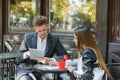 Two young business people using digital tablet on a meeting at coffee shop Royalty Free Stock Photo