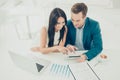 Two young business people working on new project. Man shows a woman the advantages of investing in his company Royalty Free Stock Photo