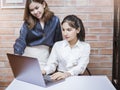 Two young business women are analytics   information on laptop screen, business meeting Royalty Free Stock Photo