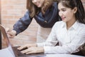 Two young business women are analytics   information on laptop screen, business meeting Royalty Free Stock Photo