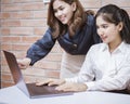 Two young business women are analytics   information on laptop screen, business meeting Royalty Free Stock Photo