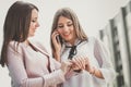Two young business women arrange a meeting via a mobile phone Royalty Free Stock Photo