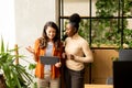 Two young business women with digital tablet standing in the modern office Royalty Free Stock Photo