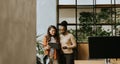 Two young business women with digital tablet standing in the modern office Royalty Free Stock Photo