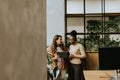 Two young business women with digital tablet standing in the modern office Royalty Free Stock Photo