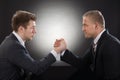 Two young businessman arm wrestling