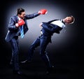 Two young businessman boxing