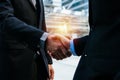 Two young businessman investor in suit shaking hands with partner during new project contract meeting in modern city Royalty Free Stock Photo