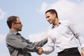 Two young businessmen shaking hands