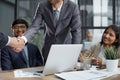 Two young businessmen are shaking hands with each other. Royalty Free Stock Photo