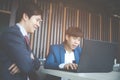 Two young businessmen using laptop at meeting Royalty Free Stock Photo