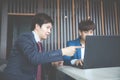 Two young businessmen using laptop at meeting Royalty Free Stock Photo