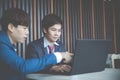 Two young businessmen using laptop at meeting Royalty Free Stock Photo