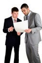 Two young businessmen working and confer