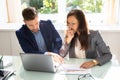 Two Young Businesspeople Analyzing Graph In Office Royalty Free Stock Photo