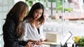 Two businesswomen having discussion planning the strategy of their new startup business in office. Royalty Free Stock Photo