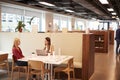 Two Young Businesswomen Having Informal Interview In Cafeteria Area At Graduate Recruitment Assessment Day