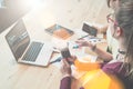 Two young businesswomen are sitting at table and discussing business plan. Royalty Free Stock Photo